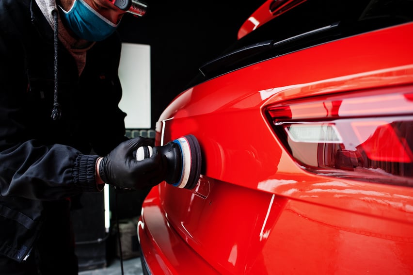 Worker Polishing Car with Orbital Polisher 