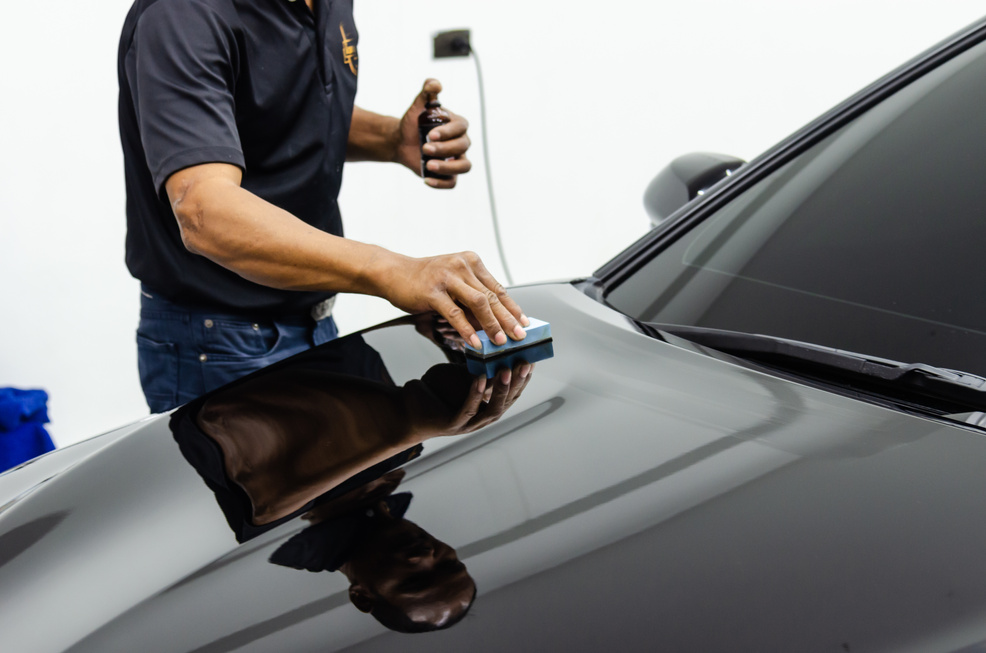 Man Applying Ceramic Glass Coating on Hood of a Car